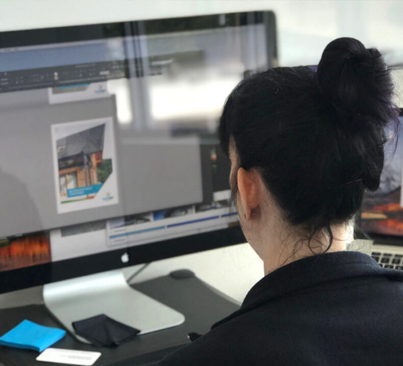 Looking over the shoulder of a woman working at a computer