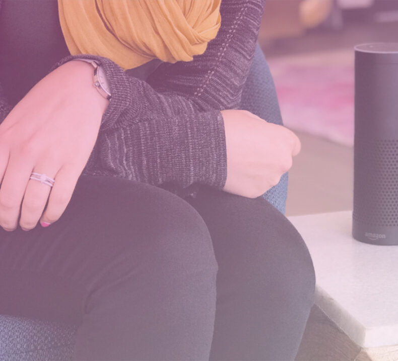 Someone sitting next to an Alexa unit