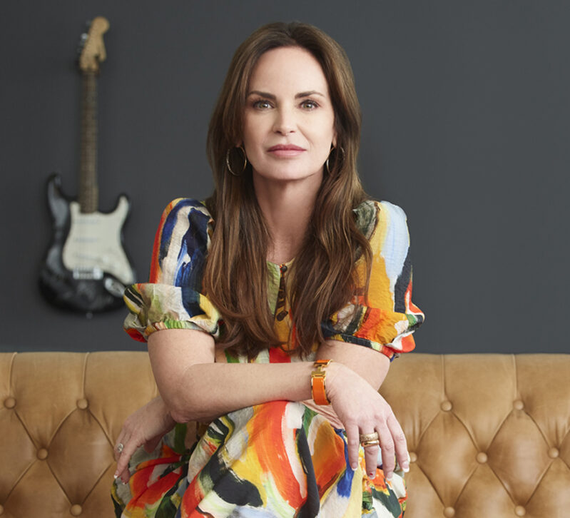 Picture of Mary Ann O'Brien, OBI Creative President and Founder, sitting on a couch at OBI Creative headquarters in Omaha, Nebraska.